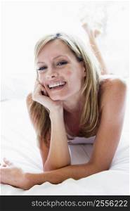 Woman lying in bed laughing