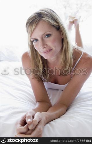 Woman lying in bed smiling