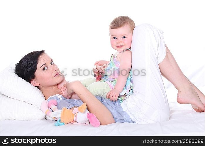 Woman lying in bed with baby