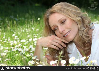 Woman lying in daisies