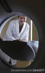 Woman lying in front of CAT scan machine