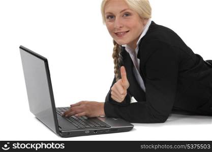 Woman lying in front of computer