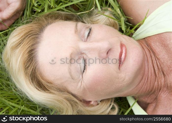 Woman lying in grass sleeping