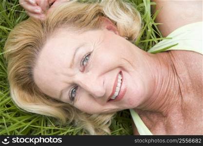 Woman lying in grass smiling