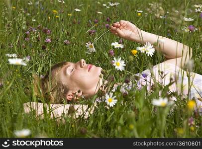 woman lying in grass with spring flowers