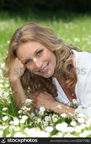 Woman lying in the daisies