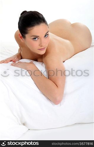 woman lying naked on bed