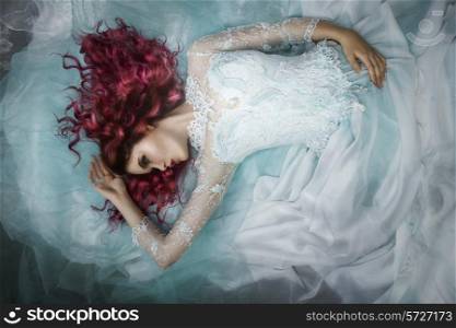 Woman lying on a dress and a tulle
