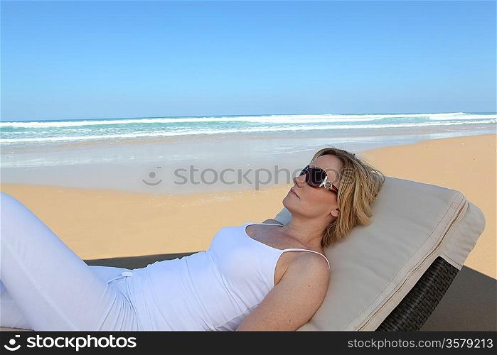 Woman lying on a lounger