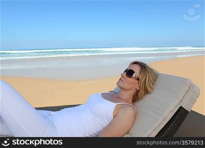 Woman lying on a lounger