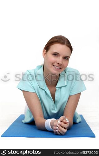 Woman lying on a yoga mat