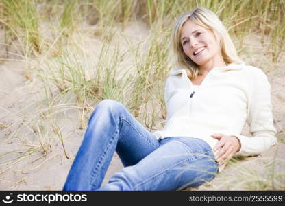 Woman lying on beach smiling