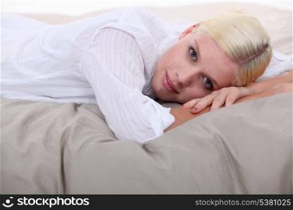 Woman lying on bed
