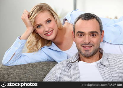 Woman lying on sofa with man