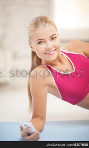 woman lying on the floor and looking into smartphone