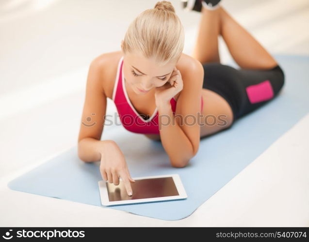 woman lying on the floor and looking into tablet pc