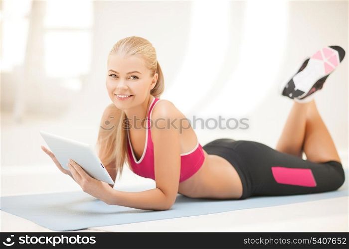 woman lying on the floor and looking into tablet pc
