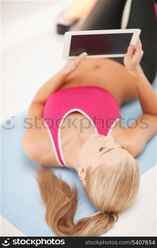 woman lying on the floor and looking into tablet pc