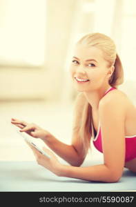 woman lying on the floor and looking into tablet pc