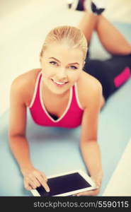 woman lying on the floor and looking into tablet pc