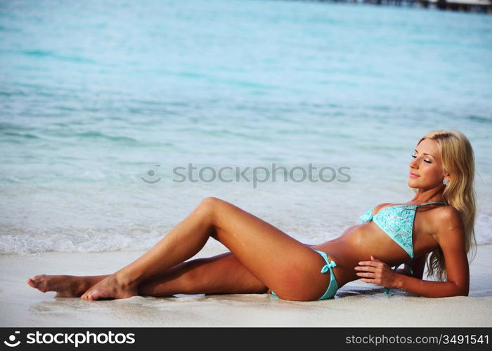 woman lying on the sand the ocean coast