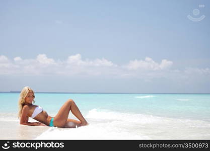 woman lying on the sand the ocean coast
