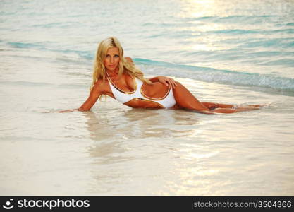 woman lying on the sand the ocean coast