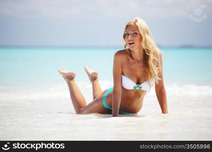 woman lying on the sand the ocean coast