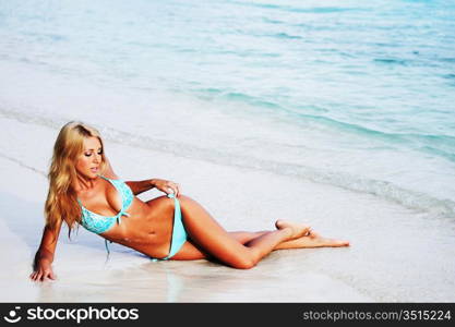 woman lying on the sand the ocean coast