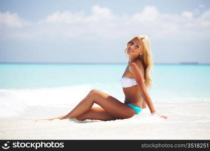 woman lying on the sand the ocean coast