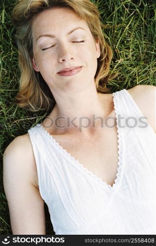 Woman lying outdoors sleeping