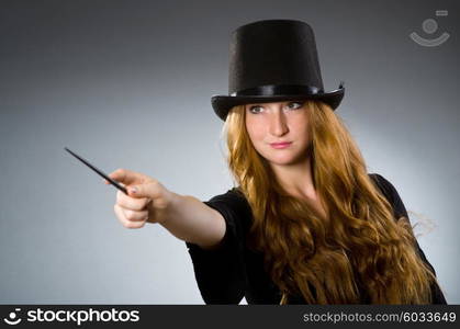 Woman magician doing her tricks with wand