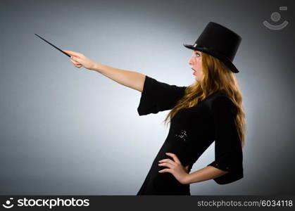 Woman magician doing her tricks with wand