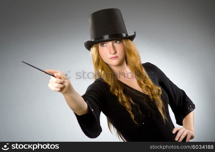 Woman magician doing her tricks with wand