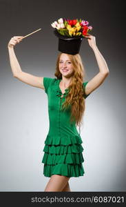 Woman magician wearing green dress