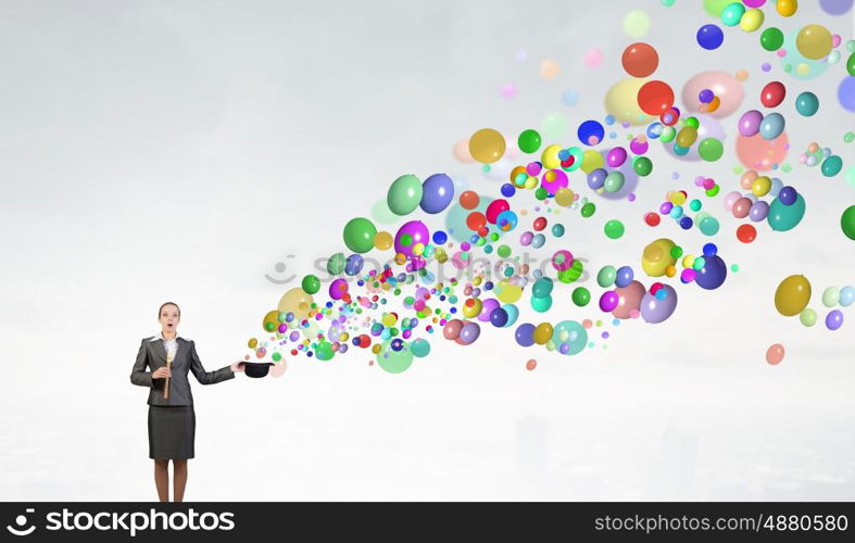 Woman magician with bowler hat. Attractive businesswoman with flute and bowler hat in hand