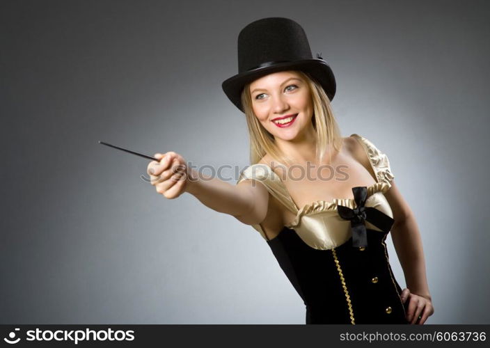 Woman magician with magic wand and hat