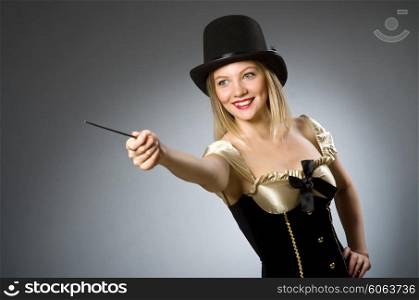Woman magician with magic wand and hat