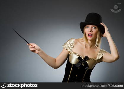 Woman magician with magic wand and hat