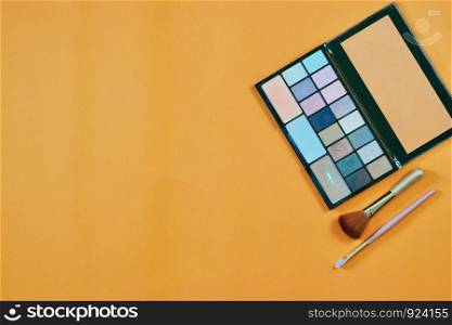 Woman makeup set on orange background