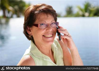 Woman making a call from the lake