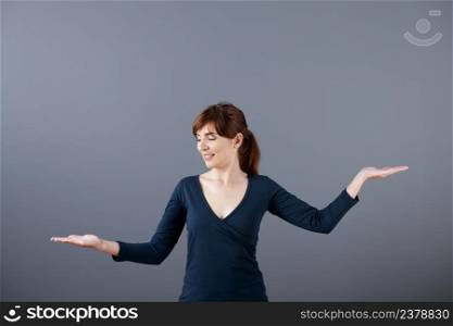 Woman making a scale with her arms