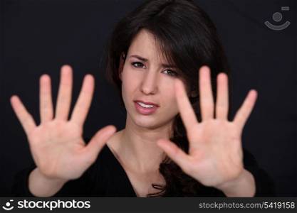 woman making a stop sign gesture with her hands