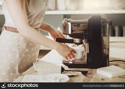 Woman making fresh espresso in coffee maker. coffee machine makes coffee. Barista Coffee Maker Machine Grinder Portafilter Concept