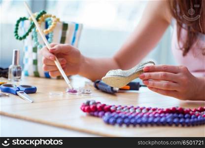 Woman making jewelry at home