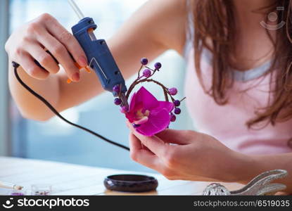 Woman making jewelry at home