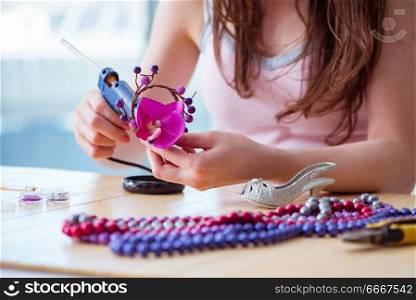 Woman making jewelry at home