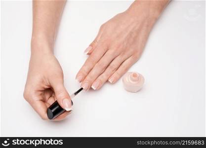 Woman making manicure by herself on grey background.. Woman making manicure by herself on grey background