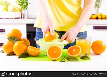 woman making orange juice in a kitchen