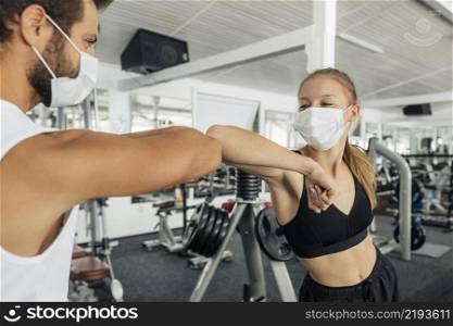 woman man doing elbow salute gym